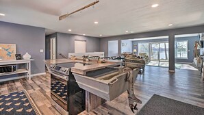 A spacious kitchen with modern appliances, a large island, and a rustic ceiling. - Charming Wausau Cottage: On-site Lake Access! (Wausau)