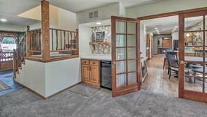 A spacious kitchen with a stone backsplash, wooden cabinets, and a built-in oven. - Screened Porch, Fenced Yard: Lakeside Retreat! (Lakeside)