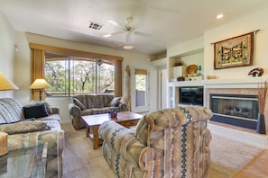 A living room with a sofa set, a coffee table, and a fireplace. - Work or Play! Resort-style Scottsdale Retreat (Scottsdale)