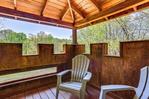 A wooden cabin with a covered porch, two Adirondack chairs, and a view of a forest. - Dreamy Indiana Cabin Rental w/ Shared Amenities! (Taswell)