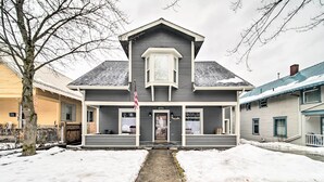 A two-story house with a front porch, a garage, and a driveway. - Charming Kellogg Home Near Outdoor Activities (Kellogg)