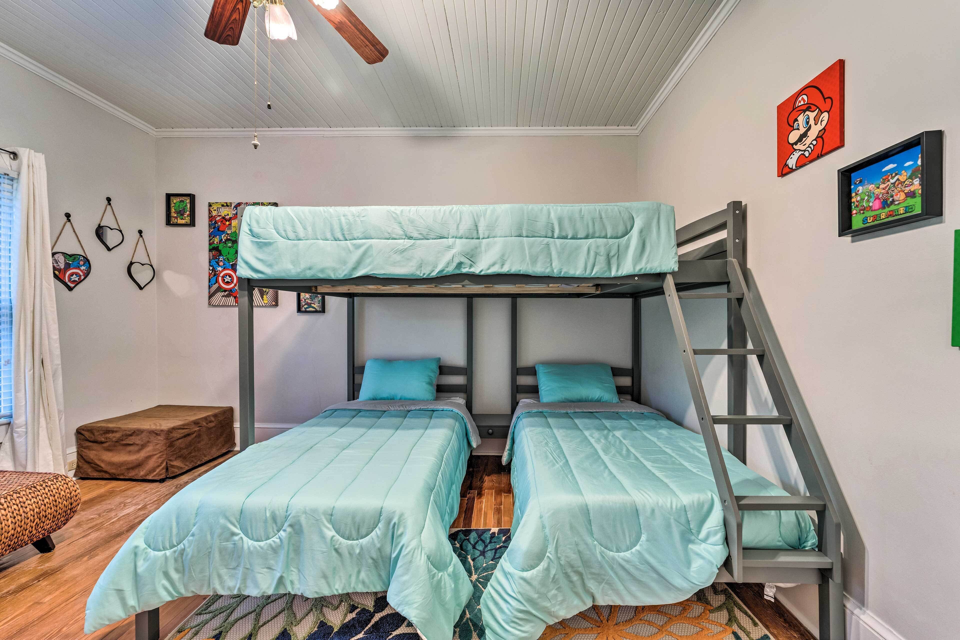 A bunk bed room with two beds, a ladder, and a window.