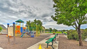 A playground with a slide, climbing structures, and a bench. - Bellemont Family Home w/ Hot Tub & Playground Set (Flagstaff)