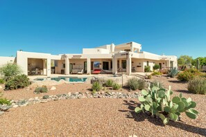 A modern two-story house with a swimming pool, surrounded by desert landscaping including cacti and agave plants. - Oro Valley Airpark Estate w/ Pool & Mtn Views (Oro Valley)