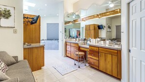 A modern bathroom with wooden cabinets, a large mirror, and a sink. - Mtn-view Oasis w/ Pool, Spa & Gym in Oro Valley! (Oro Valley)