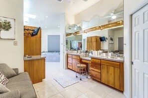 A modern bathroom with wooden cabinets, a large mirror, and a sink.