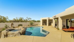 A modern outdoor pool area with a hot tub, lounge chairs, and a patio. - Mtn-view Oasis w/ Pool, Spa & Gym in Oro Valley! (Oro Valley)
