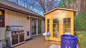 A wooden deck with a barbecue grill, a small shed, and a blue play tent. - Tranquil Abode w/ Garden, Sauna & Cold Plunge (Asheville)