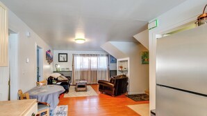A compact living space with a dining area, a sofa, a small table, and a refrigerator. - 2 Mi to Dtwn: Cozy Getaway in Fairbanks! (Fairbanks)