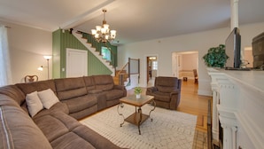 A living room with a sectional sofa, a coffee table, and a fireplace. - 3-acre Property: Charming Dutch Country Colonial (Sinking Spring)