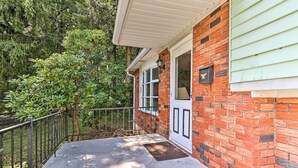 A brick house with a white door and a small porch area. - Family-friendly Allentown Abode w/ Backyard! (Allentown)