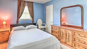 A bedroom with a bed, a dresser, a chair, and a window with curtains. - Family-friendly Allentown Abode w/ Backyard! (Allentown)
