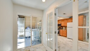 A modern kitchen with wooden cabinets and a white refrigerator. - El Cajon Oasis w/ Backyard 17 Mi to Dtwn San Diego (El Cajon)