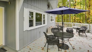 A covered deck with outdoor furniture, a table, and chairs. - Hike, Fish & Relax: Family Boone Gem w/ Views! (Boone)