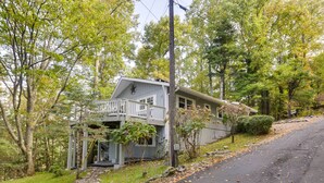 A two-story house with a balcony, surrounded by trees and a stone pathway. - Hike, Fish & Relax: Family Boone Gem w/ Views! (Boone)