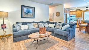 A living room with a sectional sofa, a round coffee table, and a framed picture on the wall. - Ronald Home w/ Direct Cle Elum Lake Access! (Cle Elum)