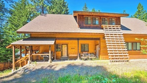 A wooden cabin with a covered porch, a staircase, and a welcome sign. - Ronald Home w/ Direct Cle Elum Lake Access! (Cle Elum)