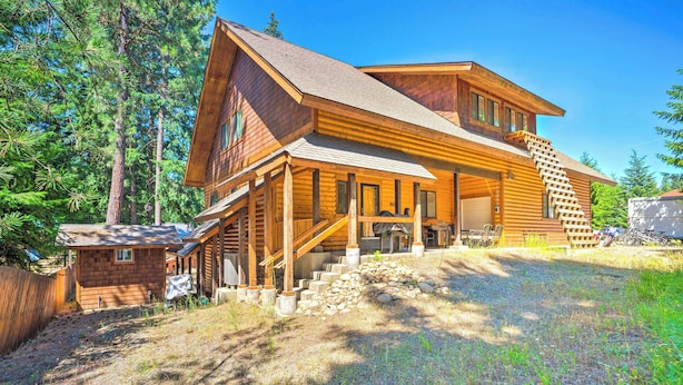 A log cabin with a prominent staircase leading to the main entrance, surrounded by a natural forest setting. - Ronald Home w/ Direct Cle Elum Lake Access! (Cle Elum)