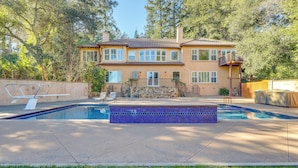 A two-story house with a swimming pool, stone facade, and a balcony. - Santa Rosa Home w/ Private Pool & Tennis Court (Santa Rosa)