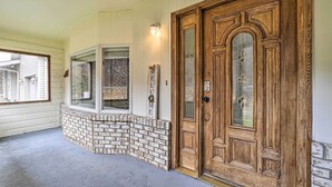 A wooden front door with a glass panel, a brick base, and a 'WELCOME' sign. - Whitesburg Vacation Home w/ Glass-enclosed Porch (Whitesburg)