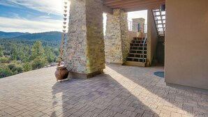 A stone structure with a view of a mountainous landscape. - Prescott Vacation Rental w/ Game Room & Mtn Views! (Prescott)