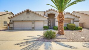A residential house with a garage, a driveway, and a palm tree. - Private Pool & Patio: Family Retreat in Mesa (Mesa)