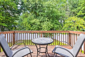 A wooden deck with a round table and two chairs. - Welcoming Abode w/ Yard ~ 1 Mi to Dtwn Apex! (Apex)