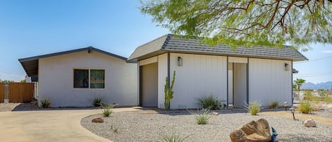 A two-story house with a covered porch and a small attached garage.