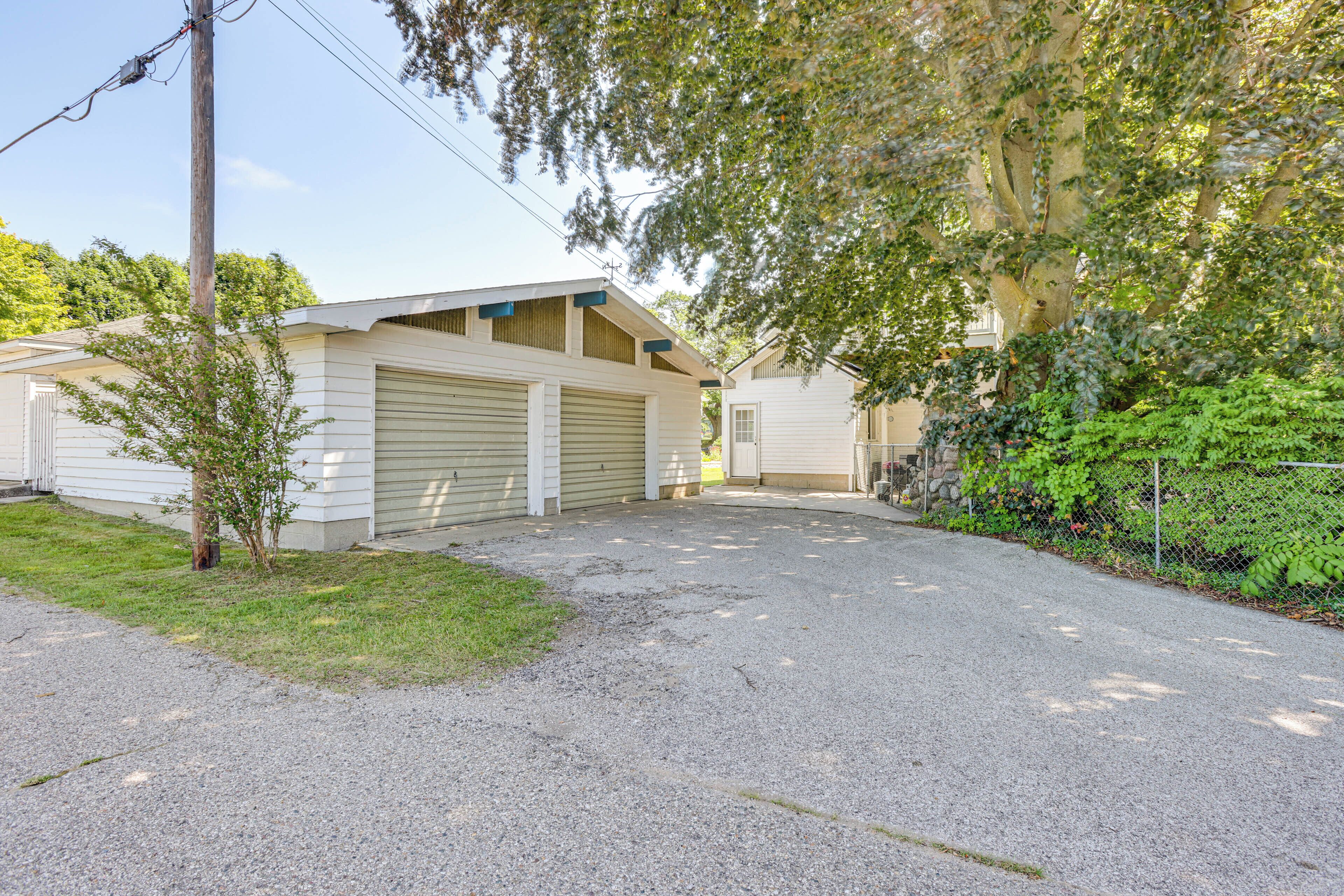 A single-story building with a garage and a small front yard.