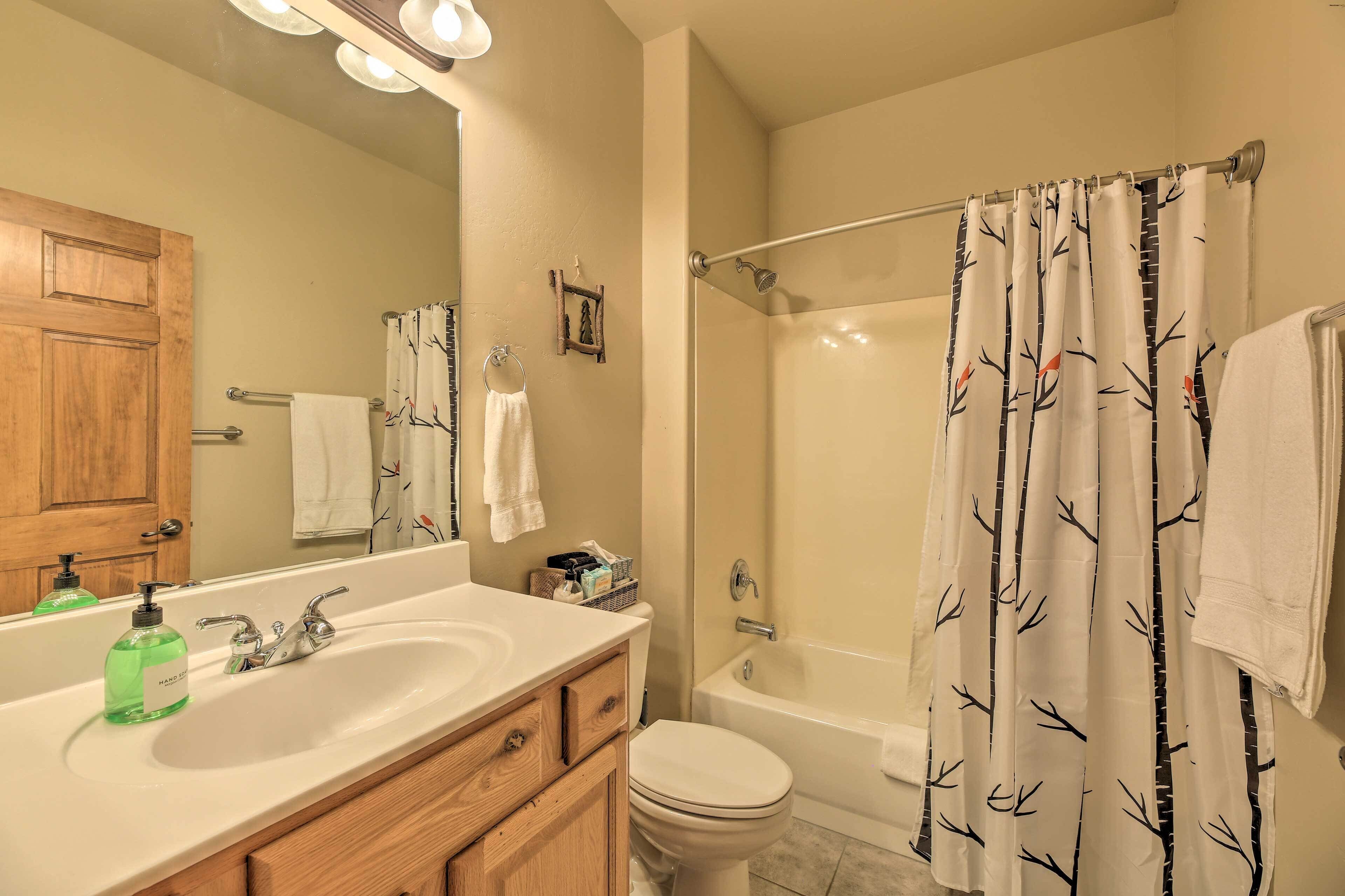 A bathroom with a sink, toilet, and bathtub.