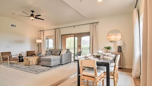 A spacious living area with a sofa, chairs, a dining table, and a ceiling fan. - Pool Access at Pet-friendly Scottsdale Condo! (Scottsdale)