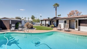 A swimming pool with lounge chairs and a covered patio area. - Private Pool & Grill: Scottsdale Getaway! (Scottsdale)