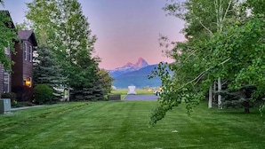 A grassy lawn with a view of mountains in the background. - Cozy Driggs Condo ~ 40 Mi to Grand Teton NP! (Driggs)