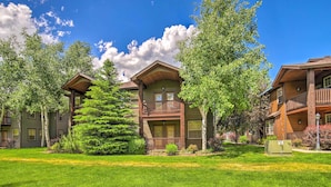 A multi-story building with a central courtyard, surrounded by lush greenery and trees. - Cozy Driggs Condo ~ 40 Mi to Grand Teton NP! (Driggs)