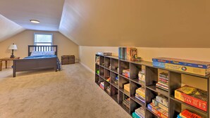 A bedroom with a bed, a bookshelf, and a window. - Charming Charleston Home w/ Yard & Fire Pit! (Charleston)