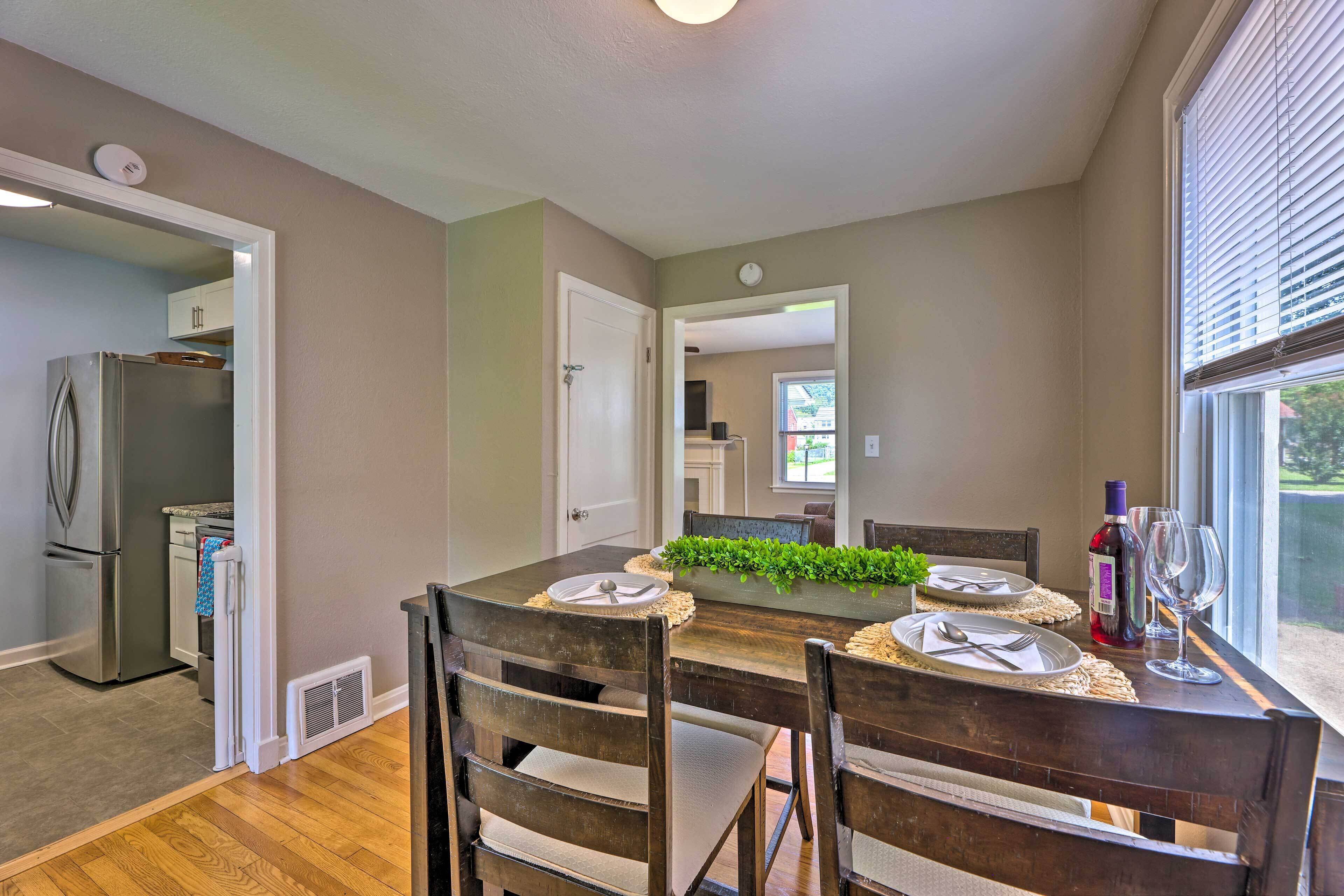 A dining area with a wooden table, chairs, and a decorative centerpiece.