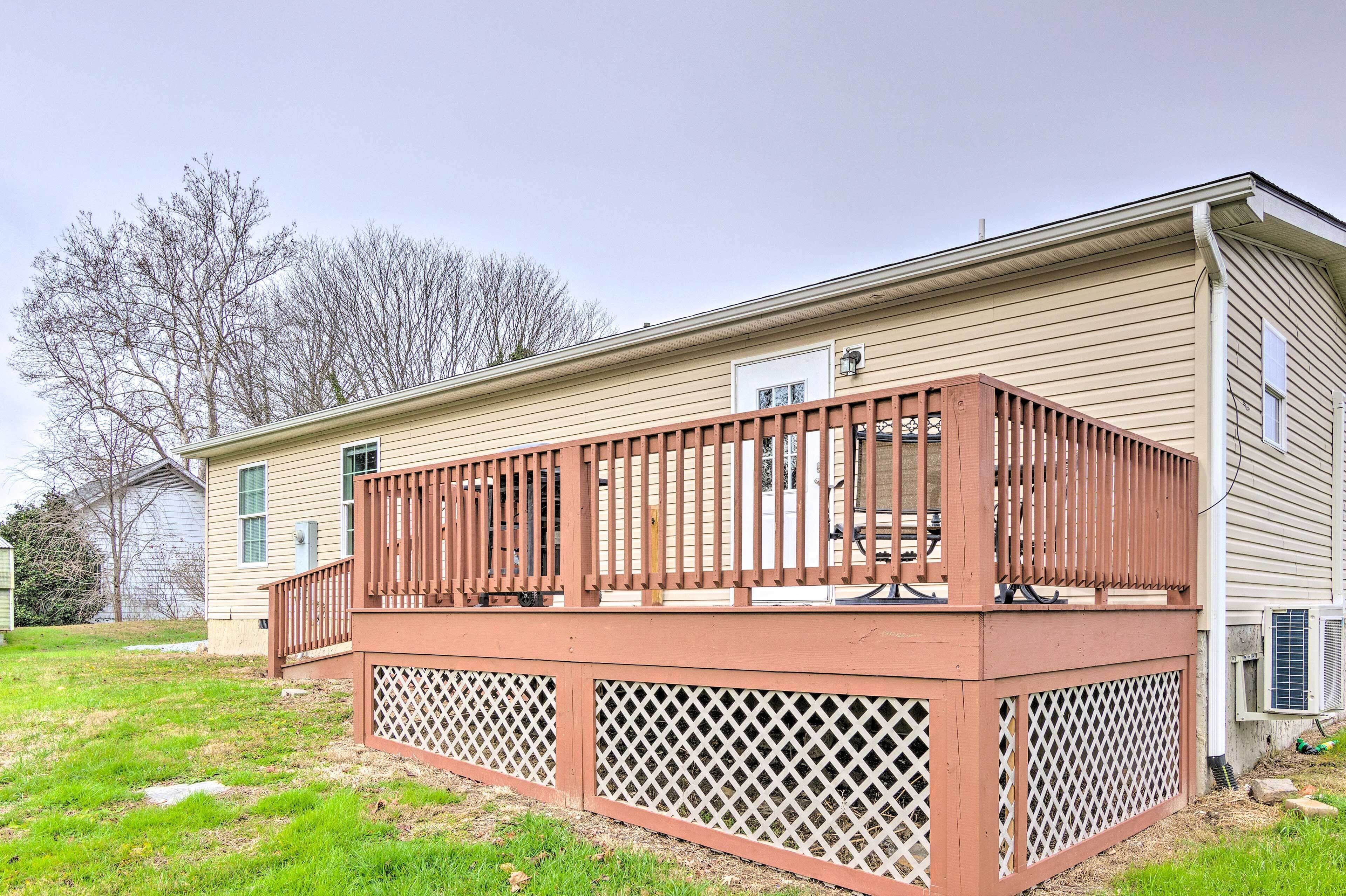 A single-story house with a wooden deck and a covered patio area.