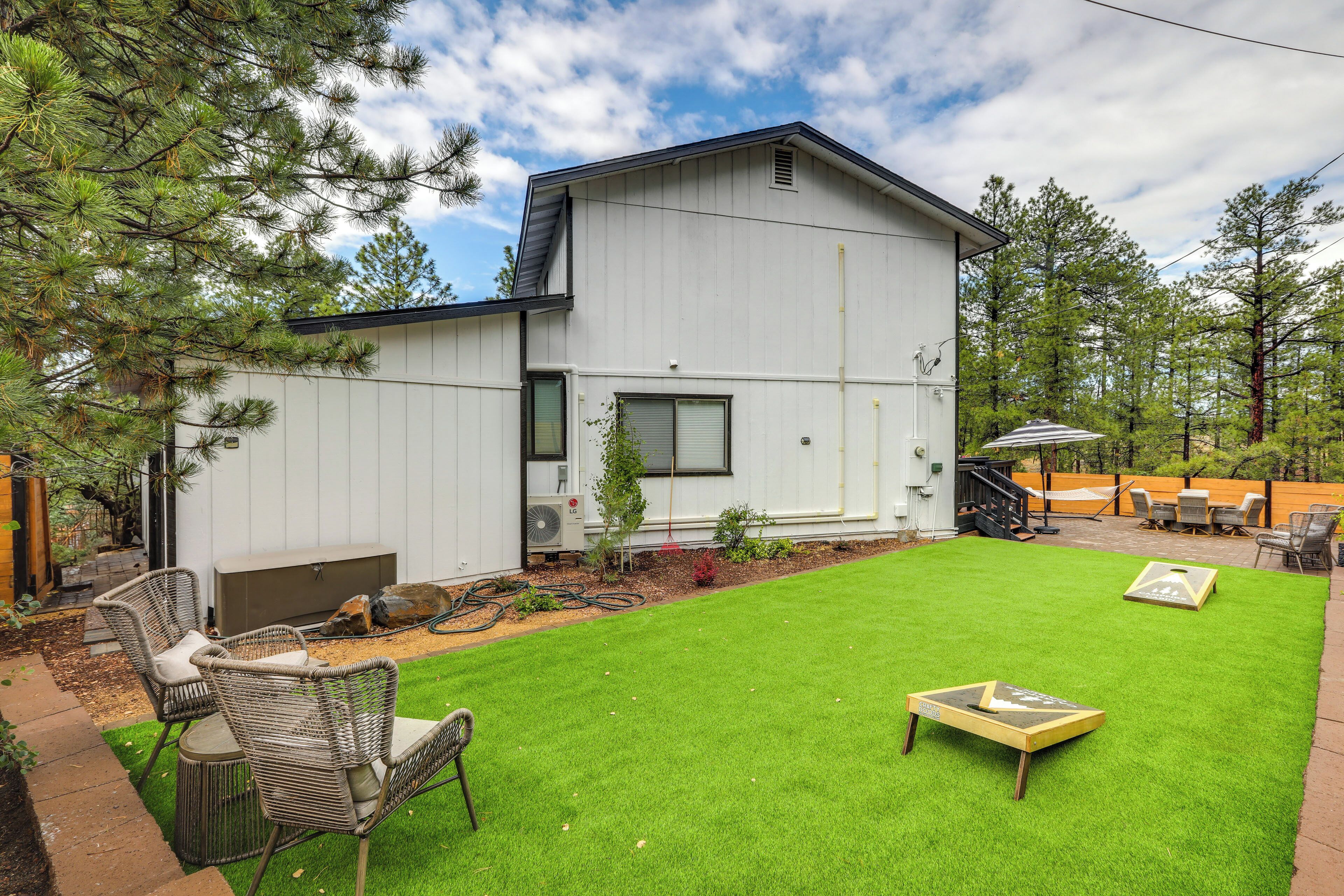 A modern house with a well-maintained lawn and outdoor furniture.