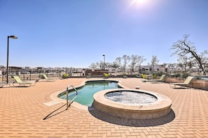 A pool area with lounge chairs and a fire feature. - Upscale Tiny Home - Boho-chic Austin Getaway! (Austin)