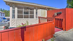 A building with a red exterior and a white facade, featuring large windows and a visible door. - \sun-dappled Retreat: Walk to Restaurants! (Boulder Creek)
