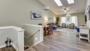 A spacious living area with a dining table, chairs, a sofa, and a ceiling fan. - Resort Condo ~ 2 Mi to Sunset Beach Seashore! (Sunset Beach)