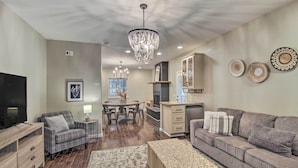 A modern living room with a fireplace, a dining area, and a kitchen. - 2 Mi to Lake: Marvelous Pinetop Home w/ Fireplaces (Pinetop)