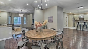 A spacious kitchen with a central island, modern appliances, and a chandelier. - 2 Mi to Lake: Marvelous Pinetop Home w/ Fireplaces (Pinetop)