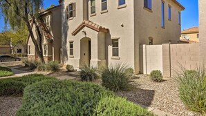 A two-story building with a beige facade, a red-tiled roof, and a small front porch. - 2-story Surprise Getaway w/ Patio + Fire Pit! (Surprise)