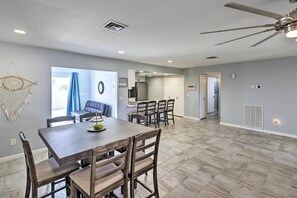A spacious dining area with a large table and chairs, a ceiling fan, and a view into the kitchen and living area. - Heated Pool: Home ~ 5 Mi to Lake Havasu! (Lake Havasu City)