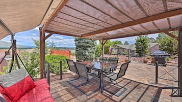 Relax and dine in style with a glass-top table and comfortable seating, surrounded by a beautiful landscape view.