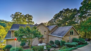 A two-story house with a brick exterior, a front porch, and a well-maintained garden. - Luxe Lake Chickamauga Retreat w/ Boat Dock! (Harrison)