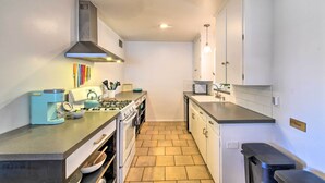 A compact kitchen with a gas stove, a coffee maker, and a microwave. - Private Desert Retreat w/ Grill & Mtn Views! (Phoenix)