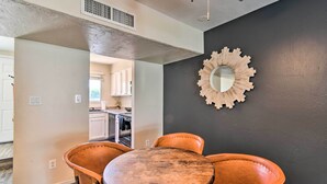 A dining area with a round wooden table and four leather chairs. - Scottsdale Townhome w/ Pool Access, Near Old Town! (Scottsdale)