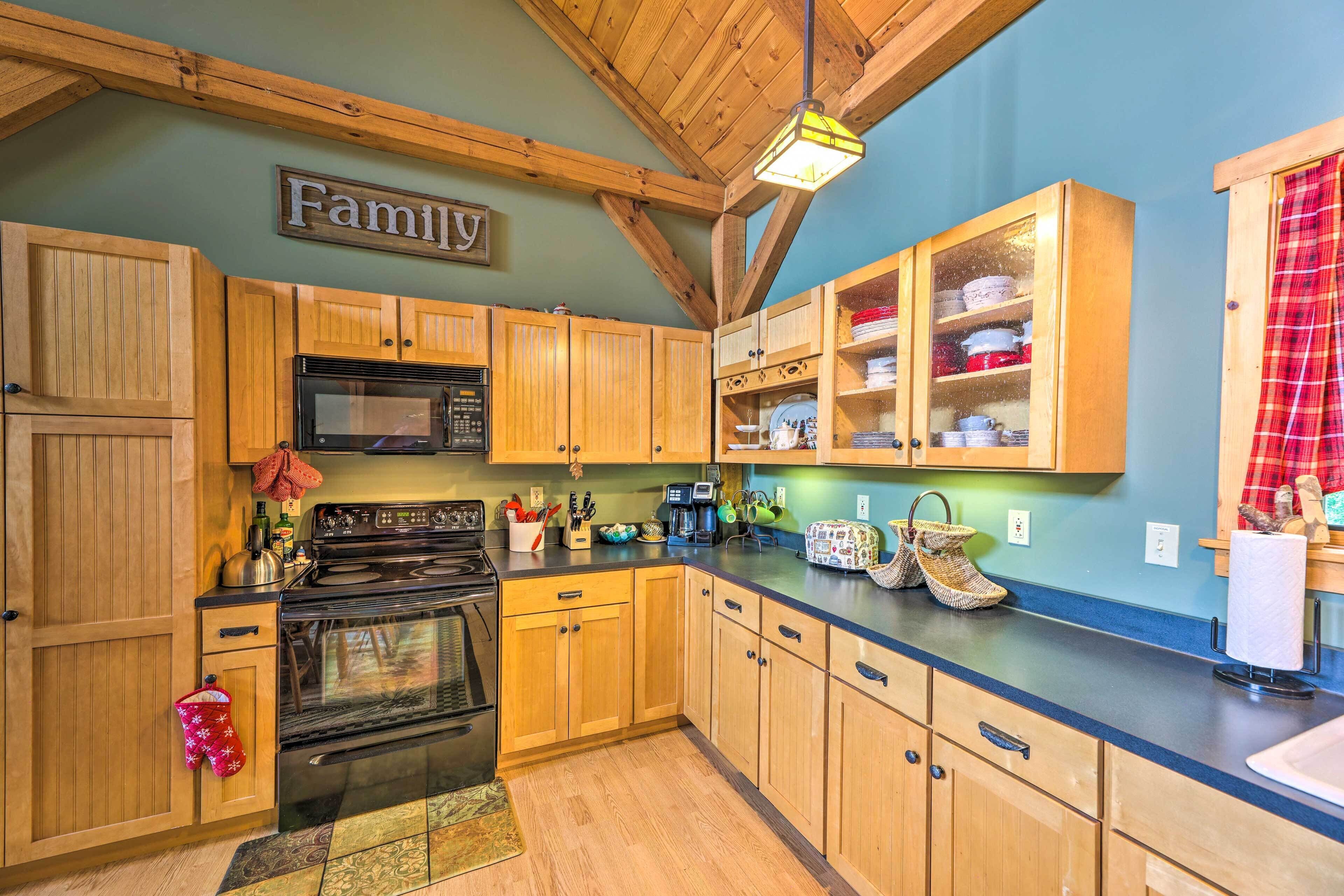 A kitchen with wooden cabinets, a stove, and a microwave.